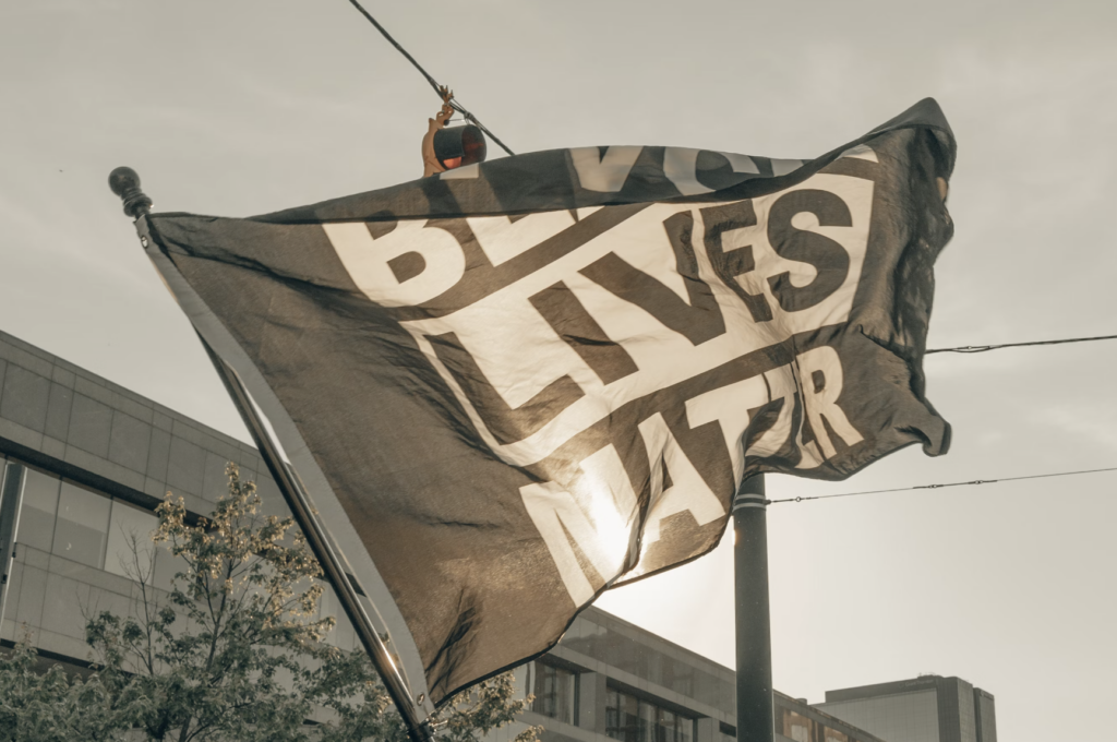 Man holds up a Black Lives Matter flag (IG: @clay.banks)